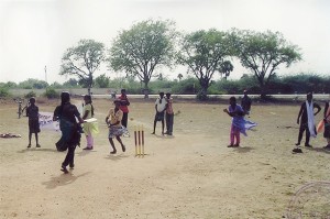 A woman running the bases in a cricket game.