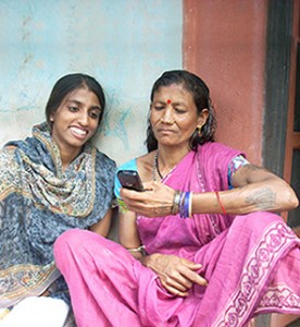 Two women in India looking at a mobile phone