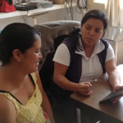 A community health worker and a woman from chiapas, mexico are sitting in an office testing the safe pregnancy and birth app on a tablet.