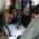 A group of African men gather around a large paper. Two of them make notes on the paper with markers.